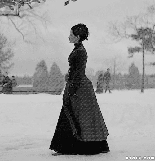寒冬中独立行走的黑衣女人图片