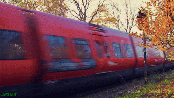 红色列车通过风情小镇动态图片